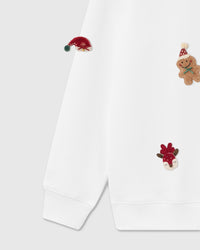 Detail of lower section showing plush elf hat, gingerbread man, reindeer, and holiday stocking on white heavyweight fleece