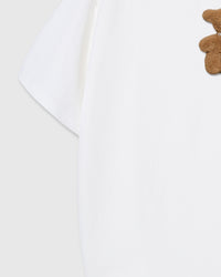 Model wearing STICKYZOO Hug-Me Bear T-Shirt in white showing dropped shoulders