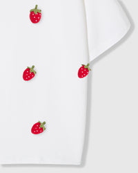 Detail of plush strawberry appliques near hem on STICKYZOO Strawberry T-Shirt in white