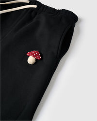 Model wearing STICKYZOO Mushroom Sweatpant in black showing elastic drawstring waist and relaxed proportions