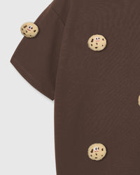 Detail of sleeve and body on STICKYZOO brown Cookie T-Shirt showing plush cookies at different angles