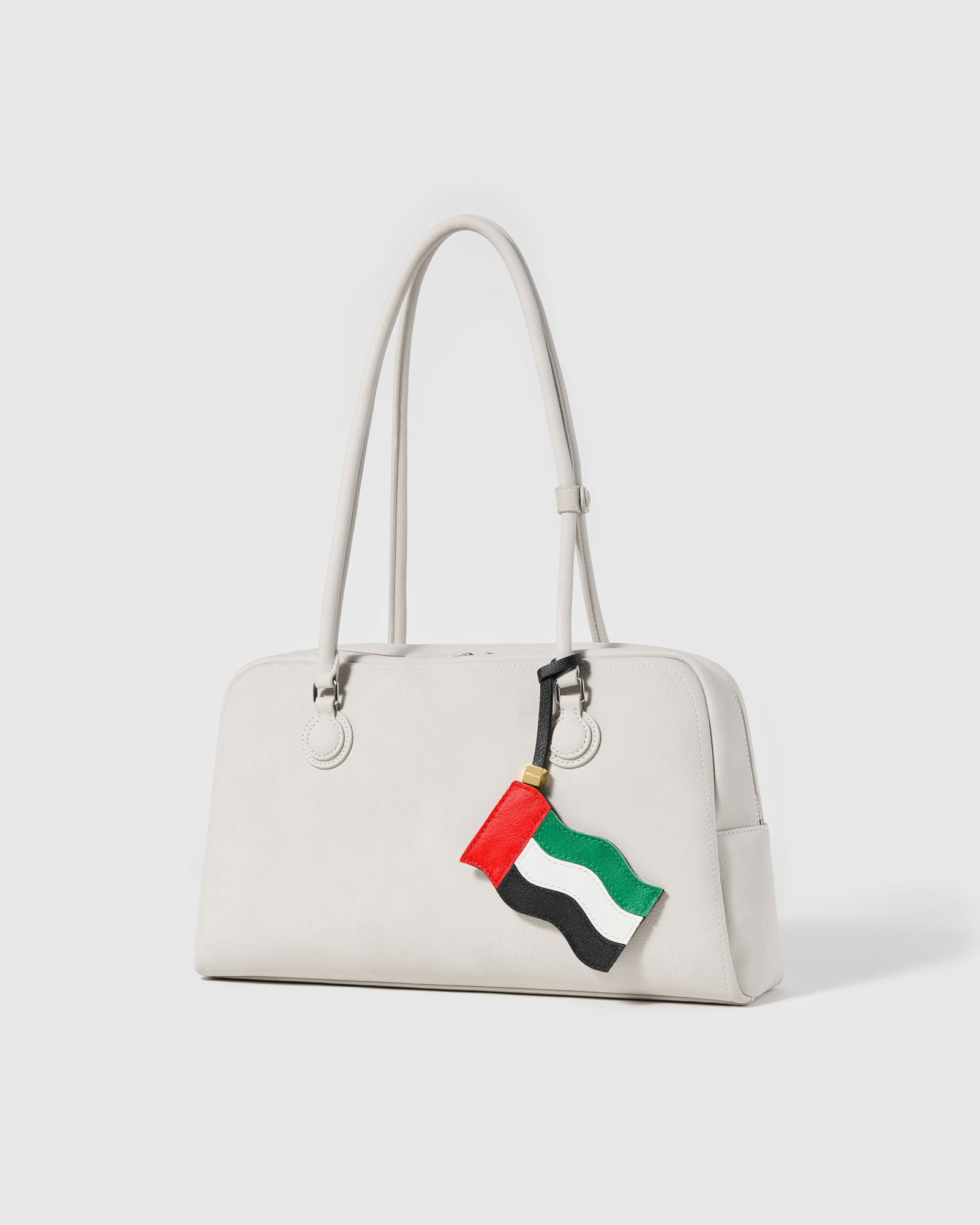 UAE flag leather charm on off-white handbag — handmade waving flag silhouette by STICKYZOO