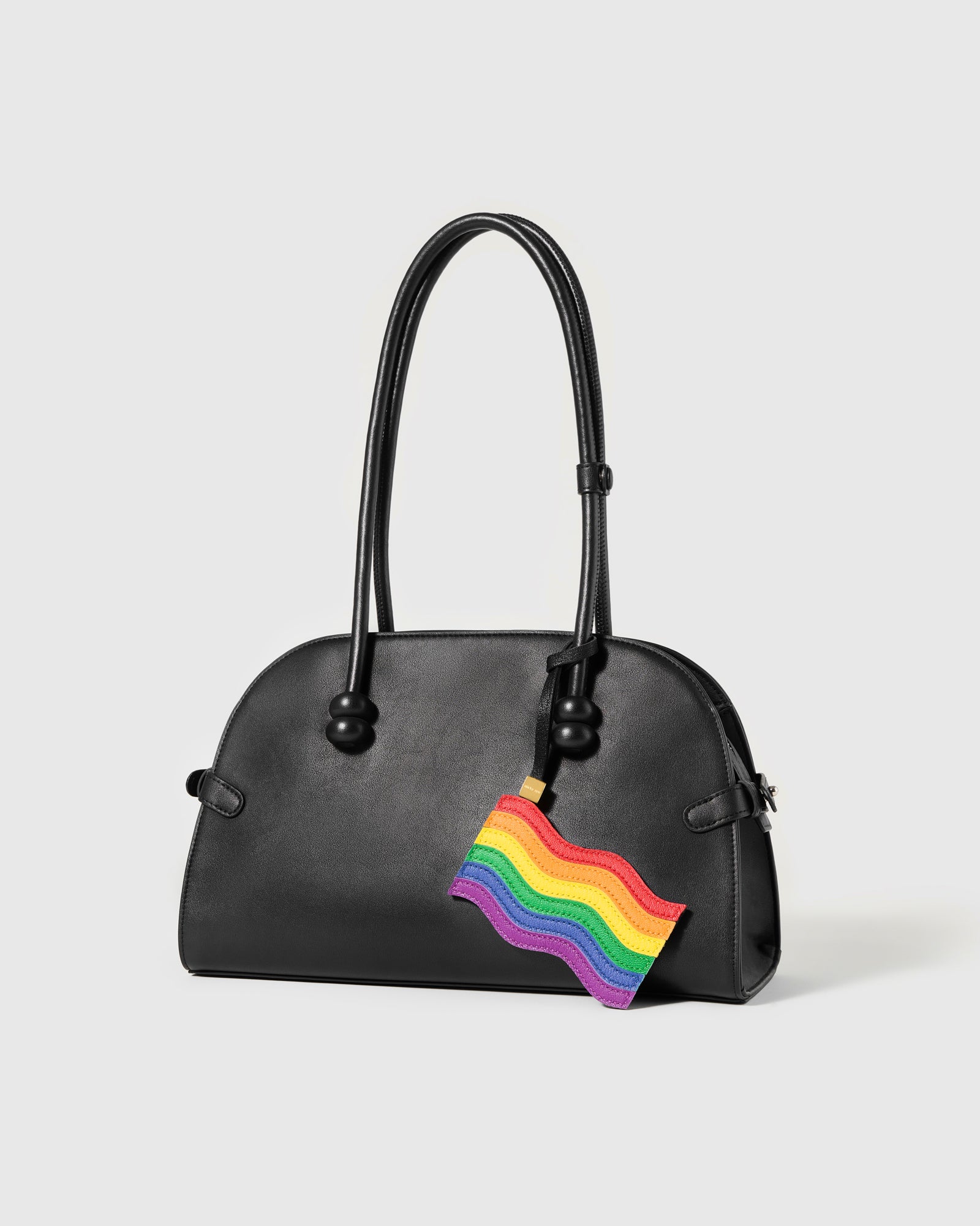 Handmade rainbow flag charm on black bag — French Alran goatskin leather by STICKYZOO
