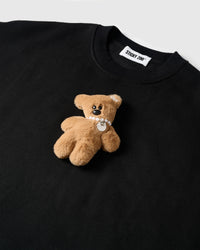 Detail of hand-stitched teddy bear applique on STICKYZOO black sweatshirt showing dimensional craft