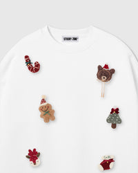 Close-up of hand-stitched plush gingerbread man, candy cane, teddy bear, and Christmas tree on white 450gsm cotton fleece