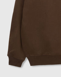 Close-up of ribbed cuff and hem on STICKYZOO brown Teddy Bear Sweatshirt showing premium construction
