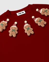 Detail of individual gingerbread plush applique on red STICKYZOO sweatshirt showing 3D texture