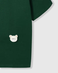 Model wearing Teddy Check-Ear T-Shirt in green showing dropped shoulders and relaxed fit