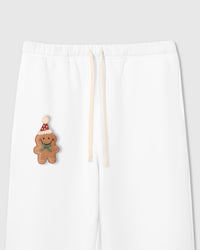 Close-up of plush gingerbread man applique with Santa hat on white heavyweight cotton fleece