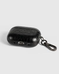 Back view of black croc case showing USB-C port, speaker cutouts, and metal carabiner
