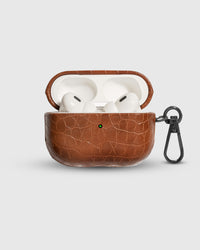Cognac Croc case open with AirPods Pro seated inside, croc-embossed lid visible
