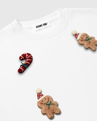 Detail of hand-stitched candy cane and gingerbread character on STICKYZOO white heavyweight fleece