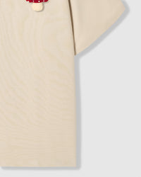 Side view of Mushroom T-Shirt in cream showing sleeve and cotton fabric