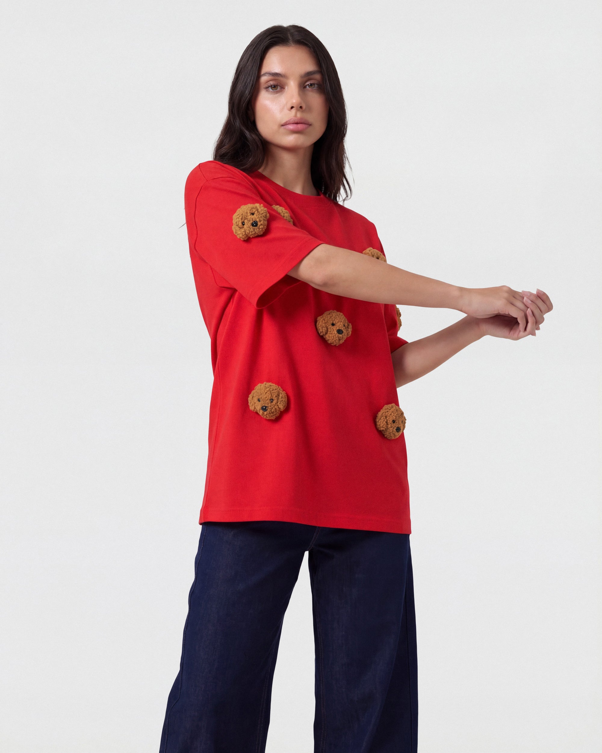 {{Rated 4.9 by thousands}} Model in red Poodle Parade T-Shirt angled pose showing plush poodle appliques and dropped sleeves