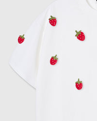 Multiple plush strawberry appliques on white cotton showing dimensional scatter pattern