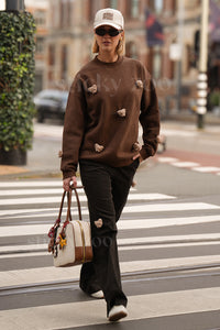 Model wearing STICKYZOO brown Sticky Bear Sweatshirt showing dropped shoulders and relaxed proportions