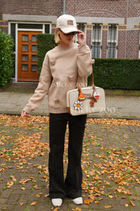 Model wearing STICKYZOO cream Sticky Bear Sweatshirt showing dropped shoulders and relaxed silhouette