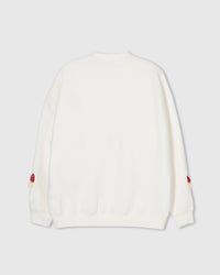 Back view of cream Mushroom Sweatshirt showing clean silhouette with plush mushrooms at sleeve cuffs