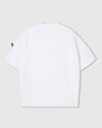 Detail of plush dachshund on white Dash Dachshund T-Shirt showing embroidered features and handmade construction