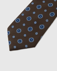 Periwinkle sunburst medallion detail on mocha mulberry silk tie showing raised hand-embroidered thread by STICKYZOO