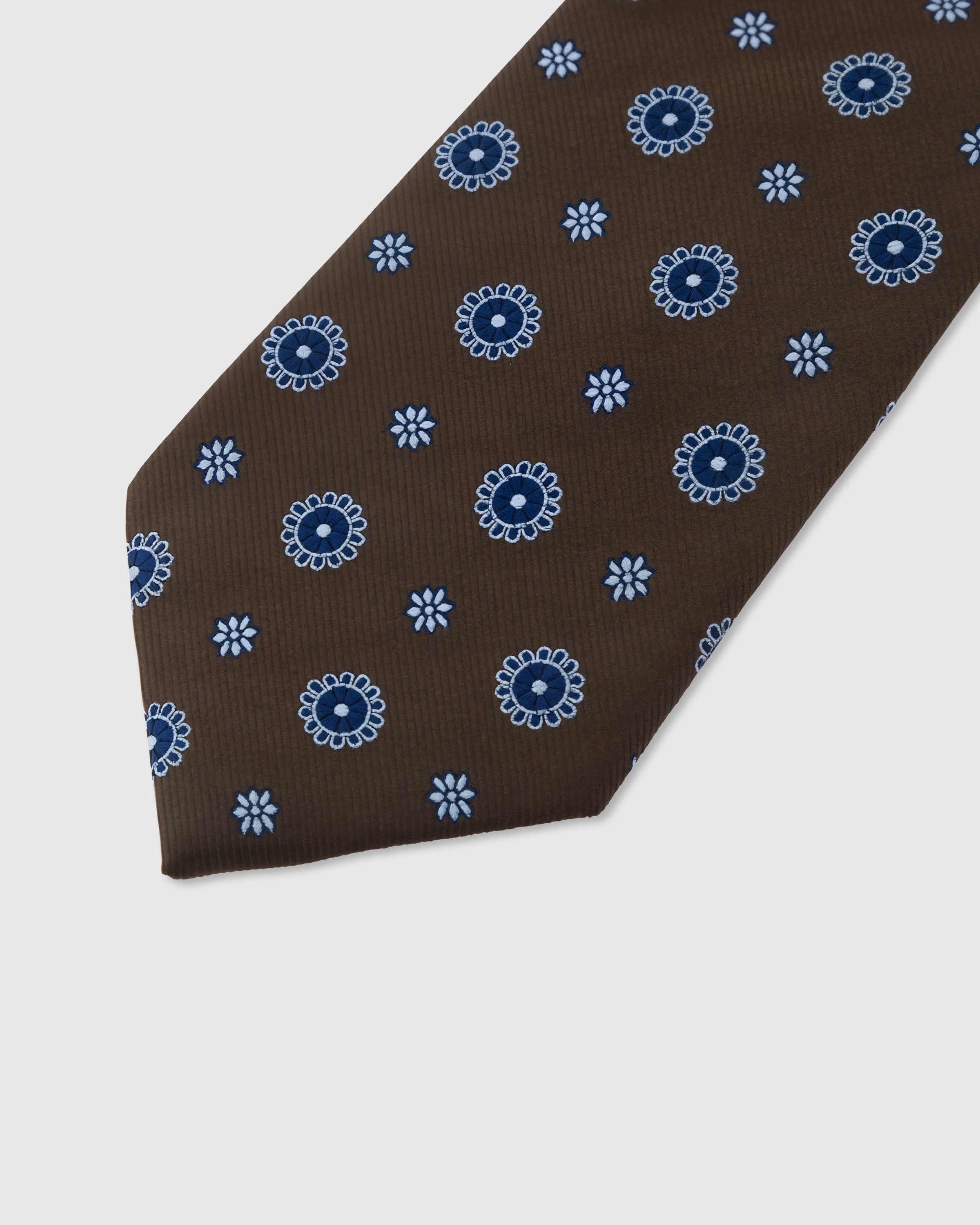 Periwinkle sunburst medallion detail on mocha mulberry silk tie showing raised hand-embroidered thread by STICKYZOO