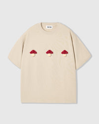 Front flat-lay of STICKYZOO Mushroom T-Shirt in cream with plush mushrooms