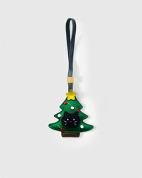 KITTEN IN CHRISTMAS TREE charm handmade from French Alran goatskin and French suede — real full-grain French leather from Tarn, since 1903. Three days of hand-cutting, hand-stitching, hand-layering. Arrives in luxury gift packaging. Designed in Amsterdam.