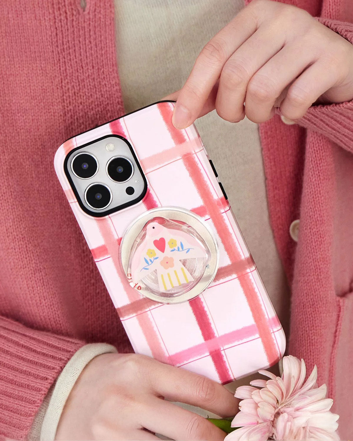 The Pink Plaid Bird Phone Case by Sticky Zoo features a soft pink plaid design paired with a delicate bird charm for a gentle, romantic everyday look. STICKY ZOO The Pink Plaid Bird Phone Case by Sticky Zoo features a soft pink plaid design paired with a delicate bird charm for a gentle, romantic everyday look. STICKY ZOO