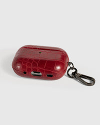 Back view of deep wine croc case showing USB-C port, speaker cutouts, and metal carabiner