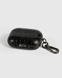 Back view of black vintage croc case showing USB-C port, speaker cutouts, and metal carabiner