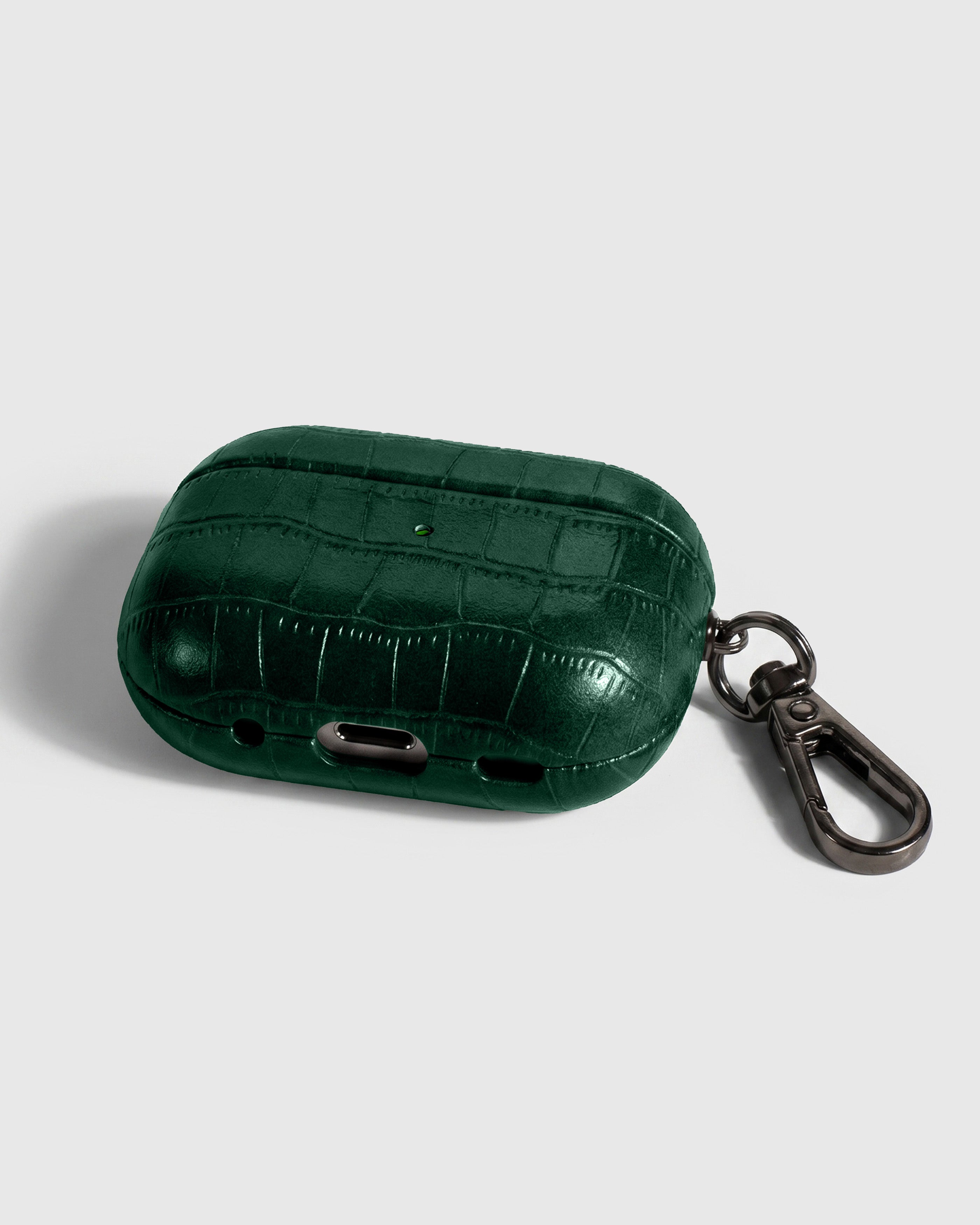 Back view of emerald vintage croc case showing USB-C port, speaker cutouts, and metal carabiner