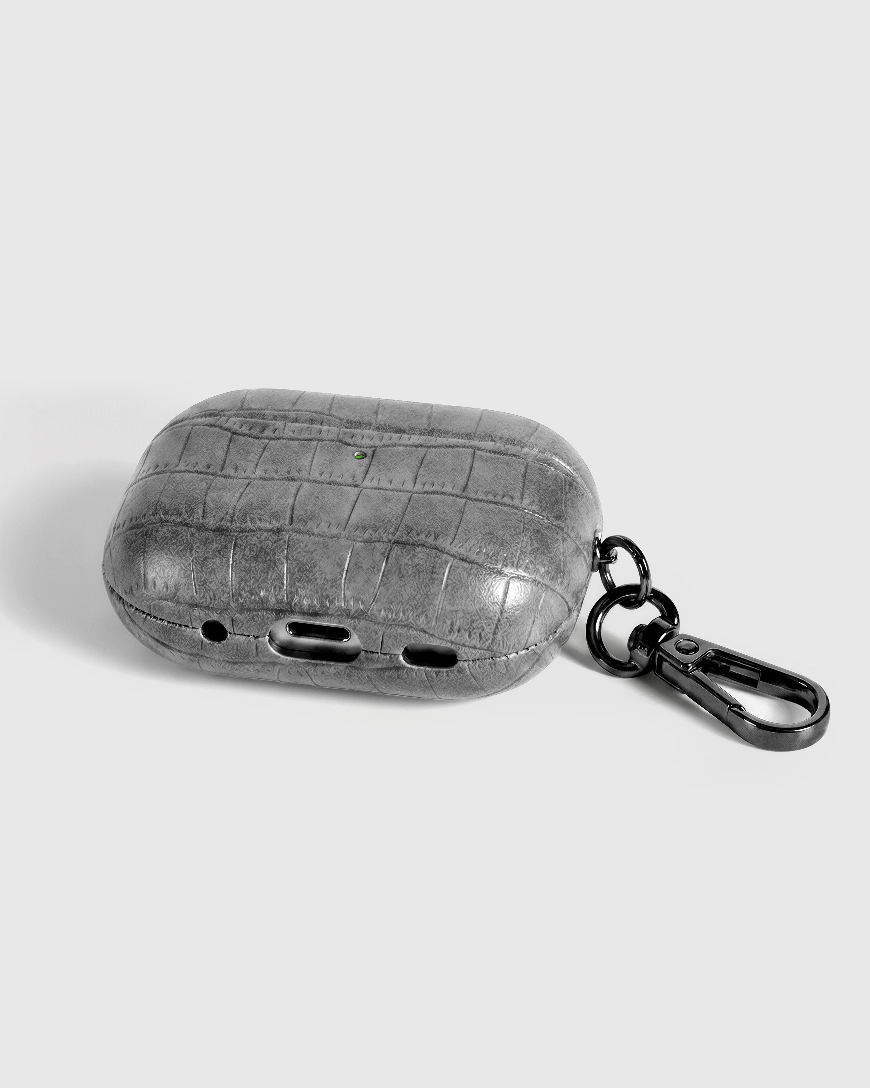 {{Kept by 99% of buyers.}} Back view of slate grey vintage croc case showing USB-C port, speaker cutouts, and metal carabiner