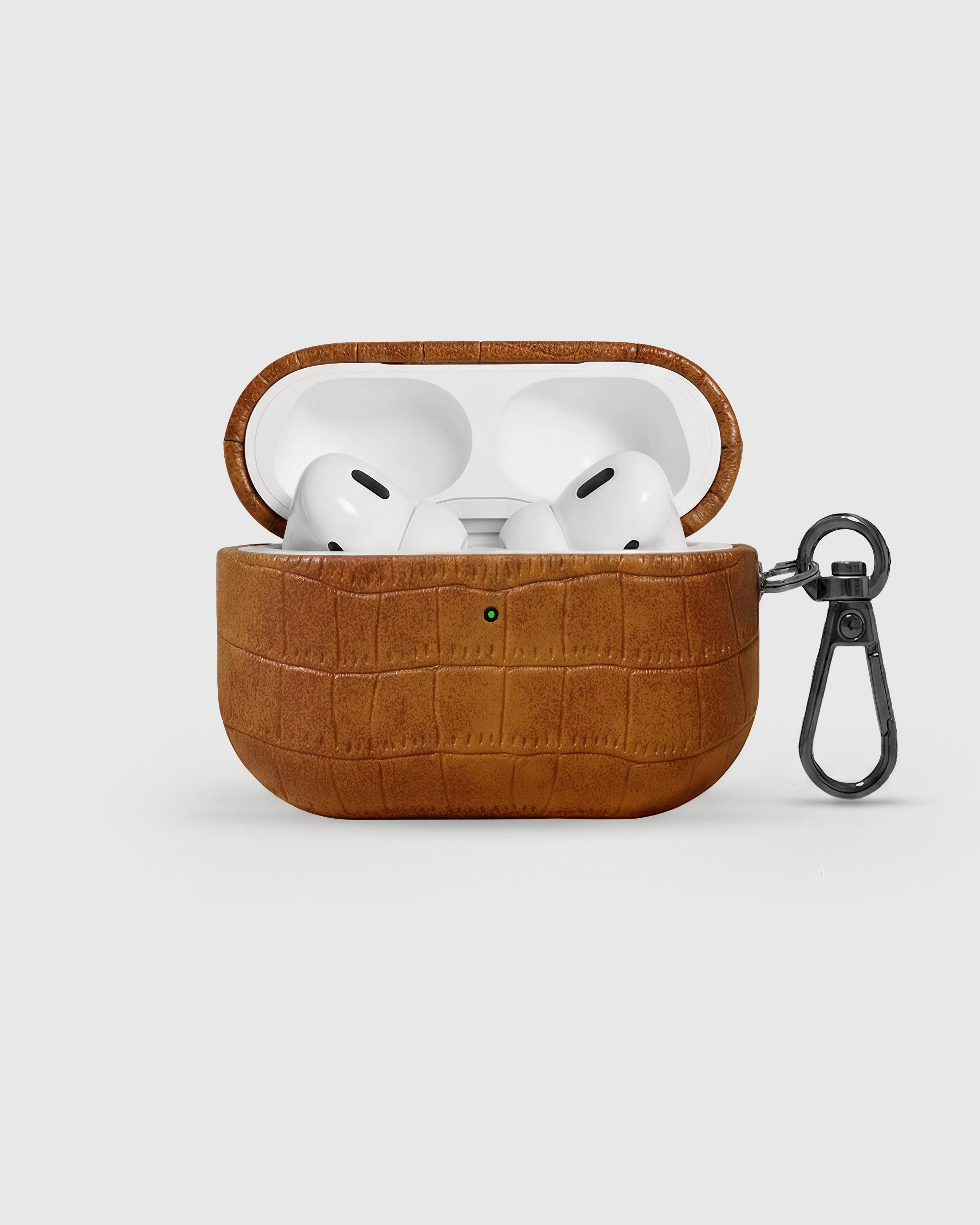 {{AirPods Pro fit securely.}} Cognac vintage croc case open with AirPods Pro seated inside