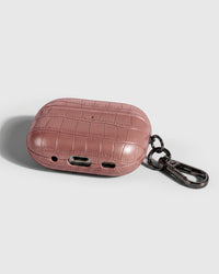 Back view of rose vintage croc case showing USB-C port, speaker cutouts, and metal carabiner