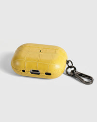 Back view of citron yellow croc case showing USB-C port, speaker cutouts, and metal carabiner