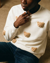 Full view of white Sticky Bear Sweatshirt showing golden plush bear faces against clean cotton