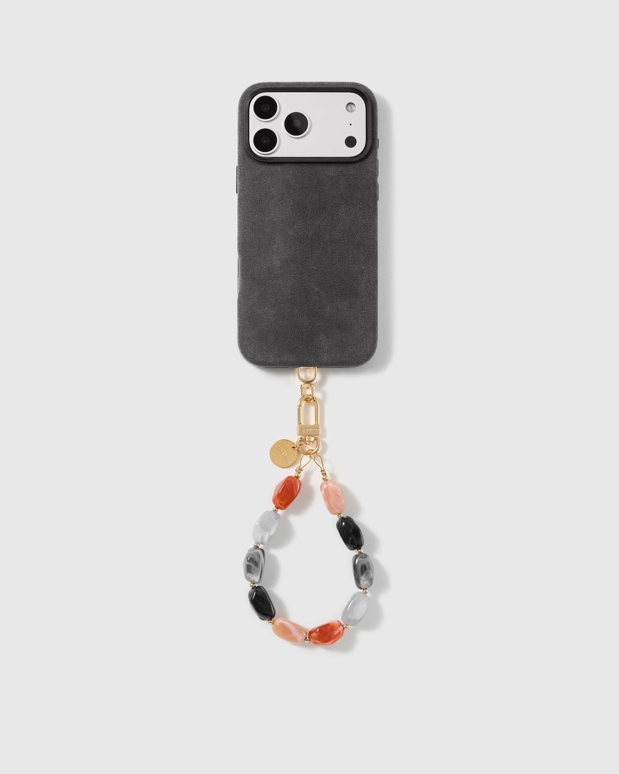 Studio shot of a phone carried by the handmade agate stone bead wrist strap, a style rated 4.9 by thousands of buyers.