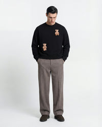 Model wearing STICKYZOO Saint Teddy Bear Sweatshirt in black showing boxy silhouette and plush bear detail