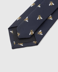 Hand-finished interior Honeybee Tie back view showing structured interlining, tipping, and embroidered bee pattern on navy silk