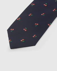 Embroidered, not printed STICKYZOO Cherry Tie flat blade showing repeating cherry motifs in red and green thread on navy silk