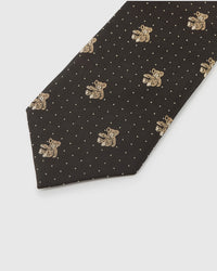 Embroidered, not printed Atlas Bear Tie flat blade showing repeating teddy bear motifs and white dots on dark brown mulberry silk