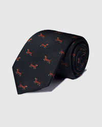 Hand-embroidered silk STICKYZOO Dachshund Tie in black with repeating brown dachshund motifs, rolled to show silk weave and embroidery