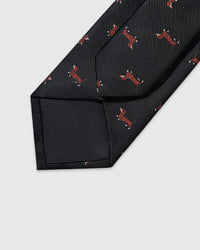 Embroidered, not printed Dachshund Tie back view showing structured interlining, tipping, and embroidered dachshund motifs on black silk