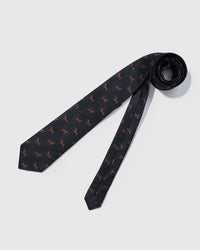 Hand-finished interior Dachshund Tie full length flat lay showing repeating dachshund motifs across the entire black silk blade