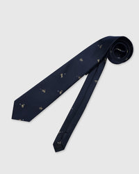 Designed in Amsterdam Golfer Tie full length flat lay showing repeating embroidered golfer motifs across the entire navy silk blade