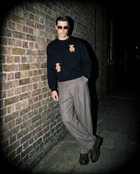 Lifestyle shot of STICKYZOO Saint Teddy Bear Sweatshirt in black on location in Amsterdam