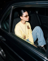 Lifestyle shot of STICKYZOO Saint Teddy Bear Sweatshirt in lemon