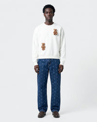 Model wearing STICKYZOO Saint Teddy Bear Sweatshirt in white showing relaxed silhouette