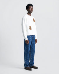 Full-body shot of white Saint Teddy Bear Sweatshirt showing dropped shoulders